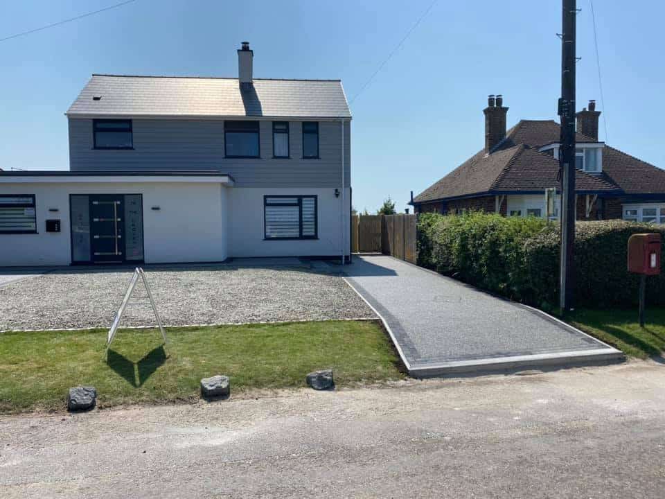 Modern driveway and pathway installation outside a residential home